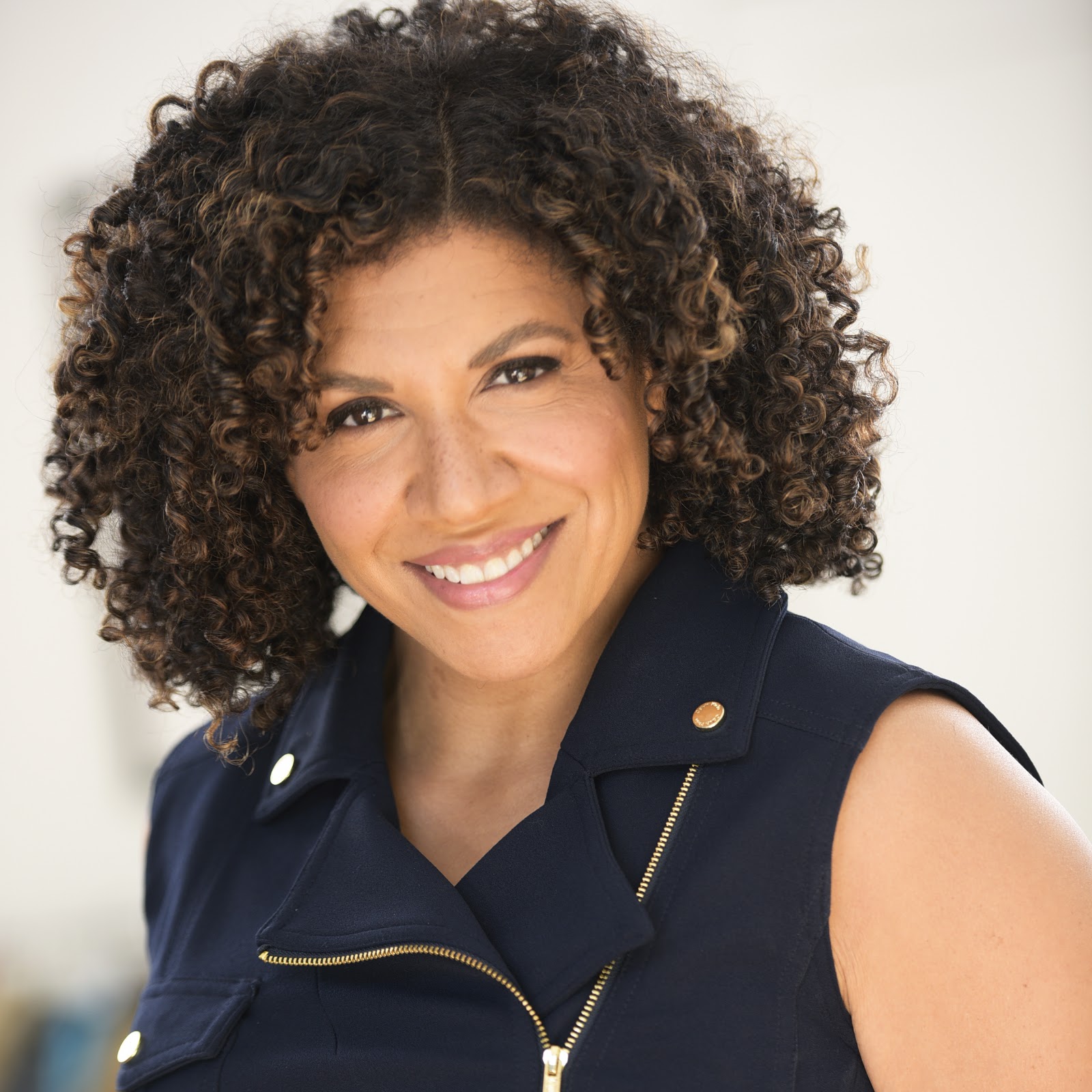 Damona Hoffman smiling, wearing a navy top