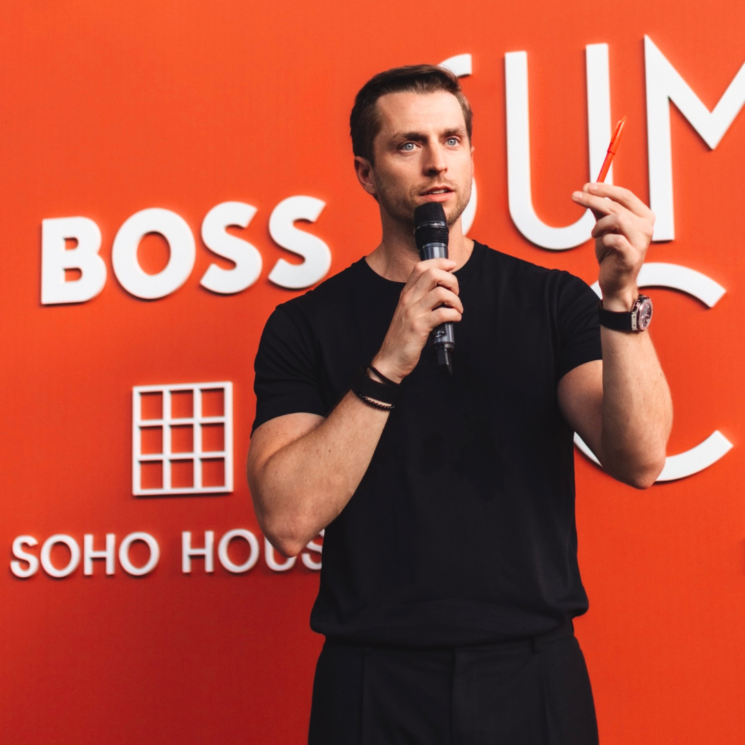 Case Kenny speaks into a microphone during a live event at Soho House.